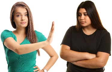 A woman holding up her hand to say stop to another woman. 