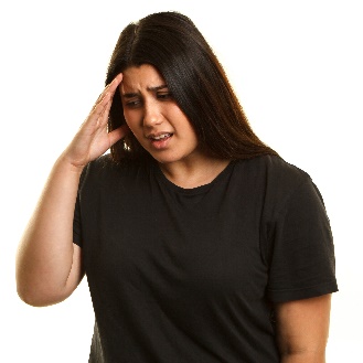 a woman with her hand to her head looking upset.