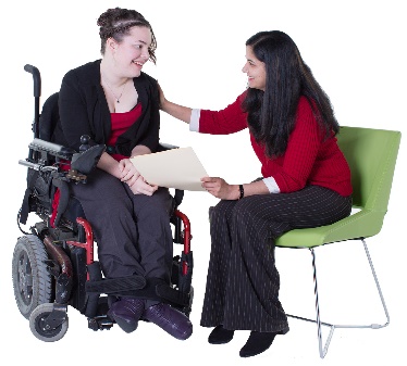 A woman explaining something in a document to a woman in a wheelchair.