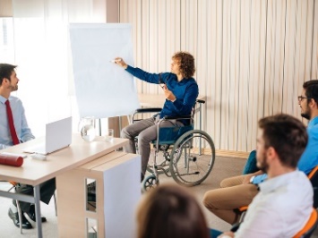 A person in a wheelchair running a training session. 