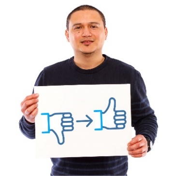 A man holding a page showing an arrow leading from a thumbs down to a thumbs up.